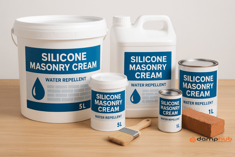 A set of silicone masonry cream containers in various sizes (1L, 5L) displayed on a wooden surface. Each container has a blue and white label reading “Silicone Masonry Cream – Water Repellent” with a droplet and brick graphic. A paintbrush and a red brick are placed in front for context, and the background is clean and bright with soft lighting.